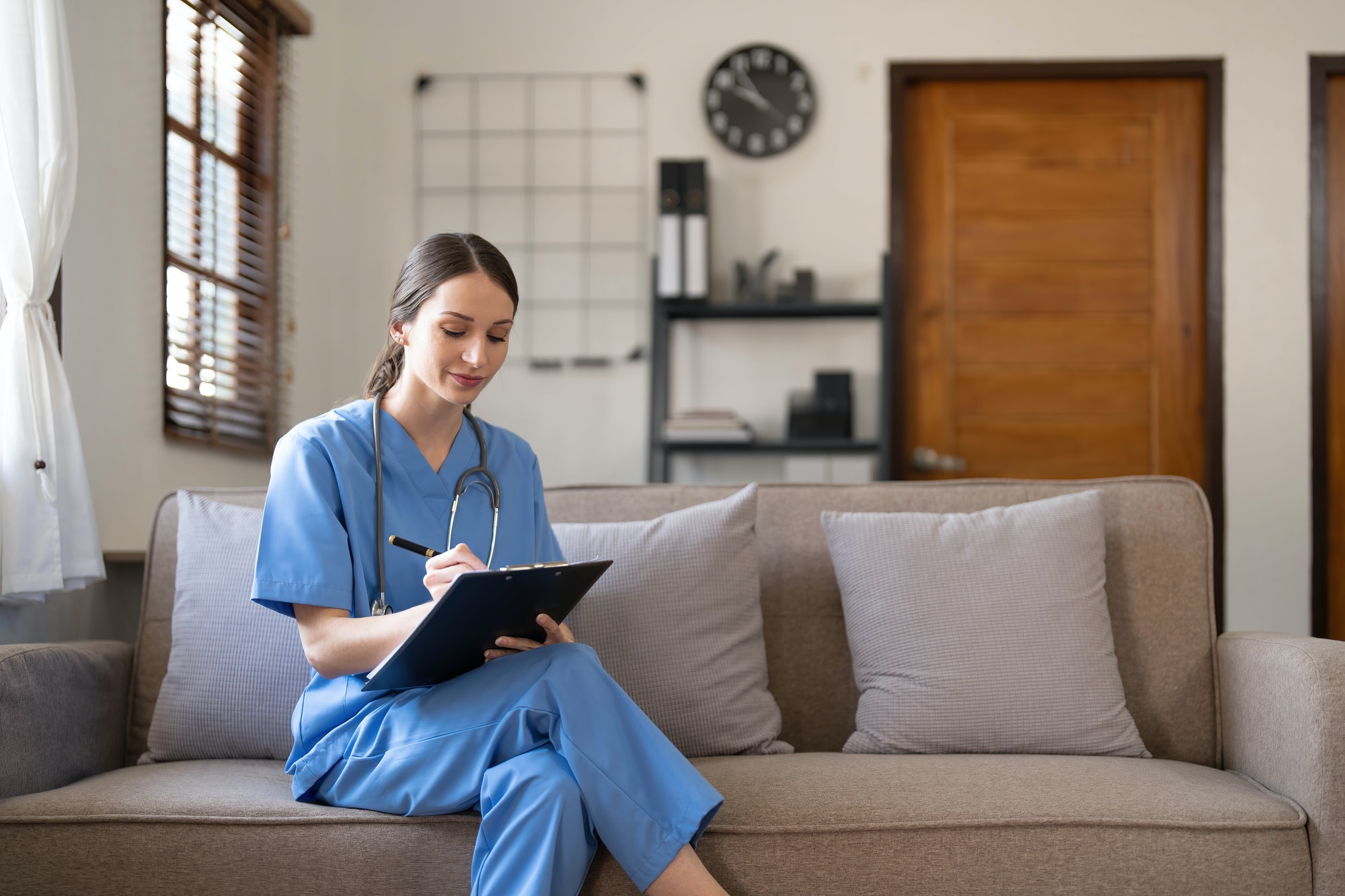 Portrait of a young Asian nurse or caregiver at home.Concept healthcare, profession, people and